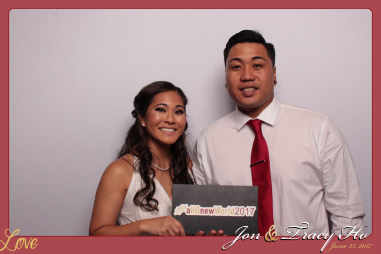 Couple posing with white backdrop and prop