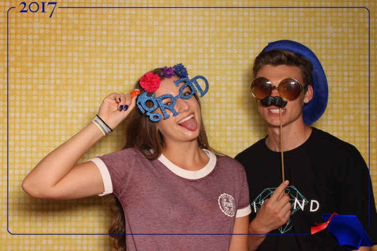Couple posing with props sunglasses and gold shimmer backdrop