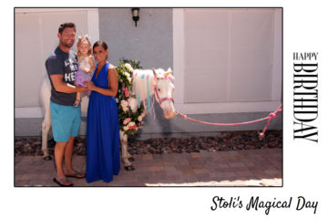 Couple with baby posing with a horse dressed as a unicorn