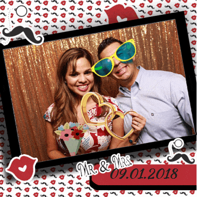 Couple posing with glasses props and shiny backdrop