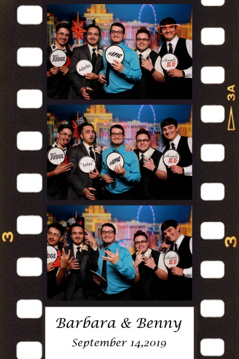 2x6 photo strip with group posing with Vegas strip backdrop and props