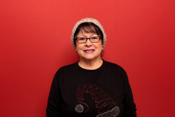 Woman posing with red backdrop