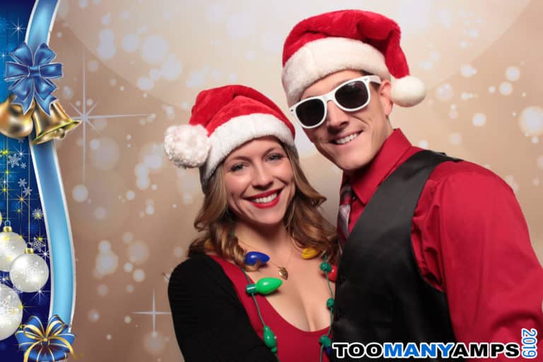 Couple posing with light bokeh backdrop and Christmas props