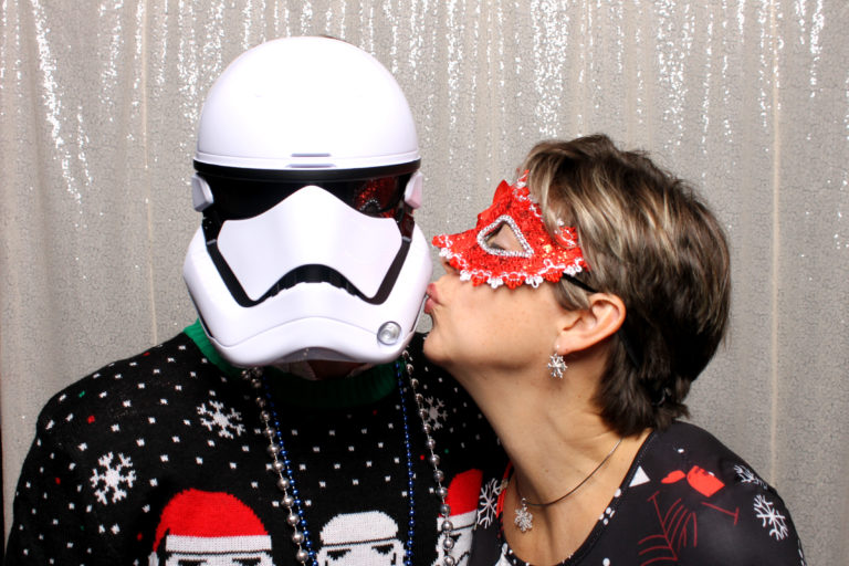 stormtrooper getting kissed in front of white backdrop
