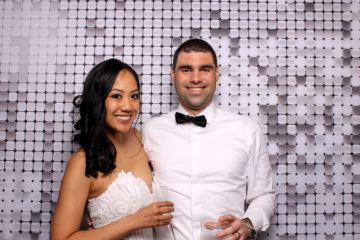 couple posing with silver shimmer backdrop Photo Booth Rentals in Las Vegas Smash Booth
