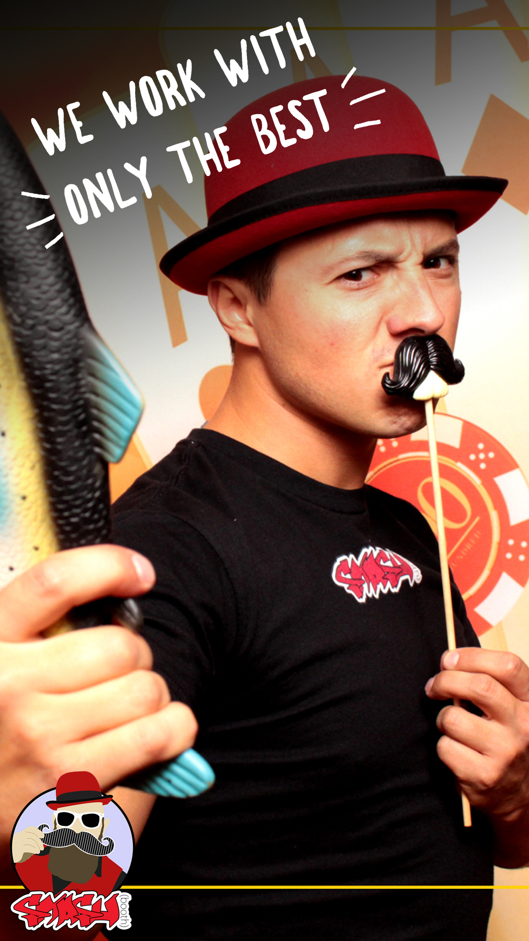 Smashbooth employee in red hat and vest with mustache prop
