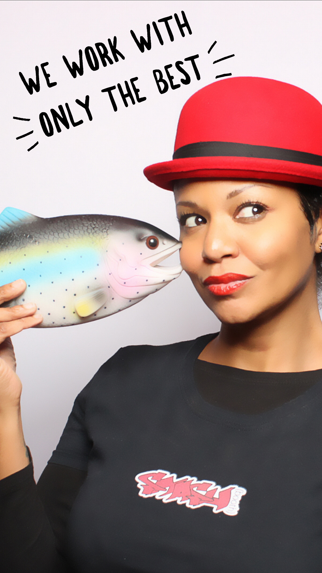 Smashbooth employee in red hat and vest with fish prop