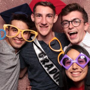 group posing with graduation props and shiny background Photo Booth Rentals in Las Vegas Smash Booth