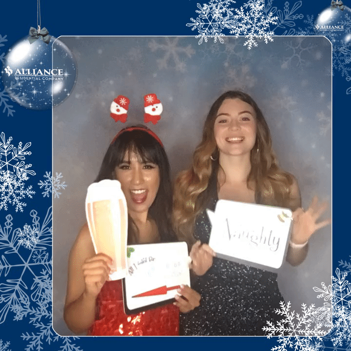 women posing with Christmas backdrop and props gif