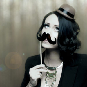 woman posing with small hat and mustache props Photo Booth Rentals in Las Vegas Smash Booth