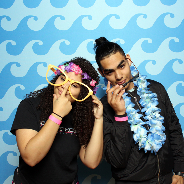 couple posing with under the sea backdrop and props