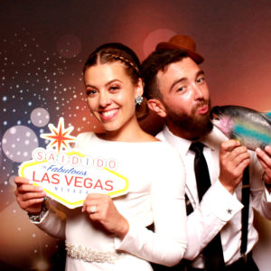 couple posing with backdrop and Vegas props Photo Booth Rentals in Las Vegas Smash Booth