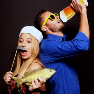 couple posing with black backdrop and props Photo Booth Rentals in Las Vegas Smash Booth