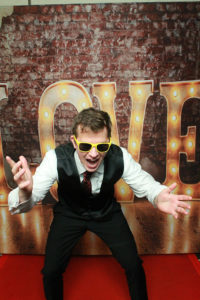 man in sunglasses posing with love letters backdrop Photo Booth Rentals in Las Vegas Smash Booth