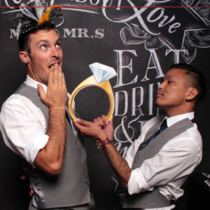 two men posing with chalkboard backdrop and ring prop Photo Booth Rentals in Las Vegas Smash Booth