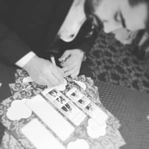 black and white image of man signing album