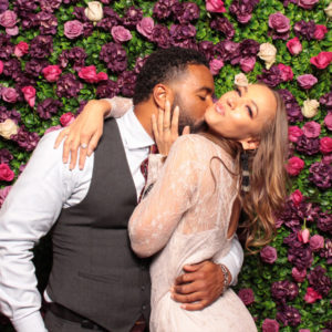 couple kissing with rose wall backdrop Photo Booth Rentals in Las Vegas Smash Booth