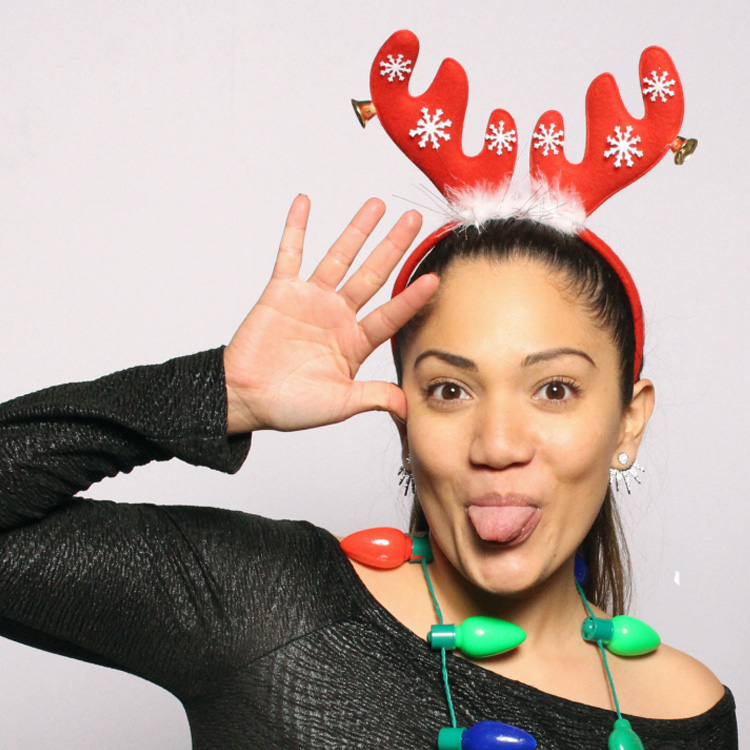 woman with Christmas props posing with white backdrop
