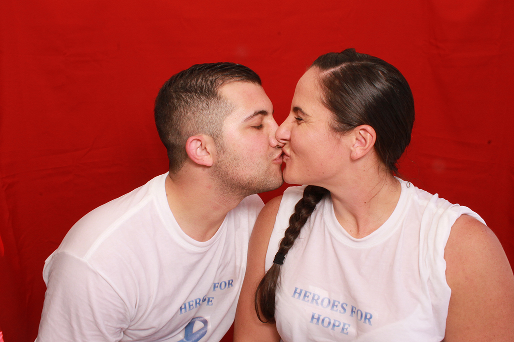 couple kissing red background