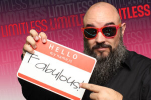 Guest-holding-Fabulous-sign-in-front-of-step-and-repeat-style-background-at-Smash-Booth-photo-booth