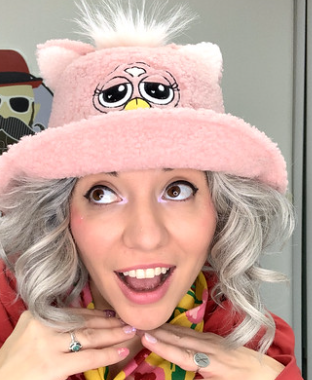 woman-with-gray-hair-wearing-pink-hat-smiling