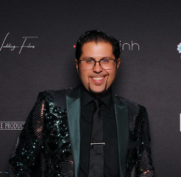 man-in-black-sequin-jacket-posing-at-a-smash-booth-corporate-event