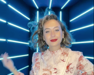 woman-posing-with-braided-hair-in-front-of-blue-led-light-booth-at-smash-booth