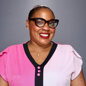 woman-in-glasses-smiling-at-smash-booth-award-ceremony