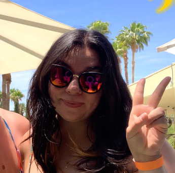 woman-in-sunglasses-showing-peace-sign-at-outdoor-event