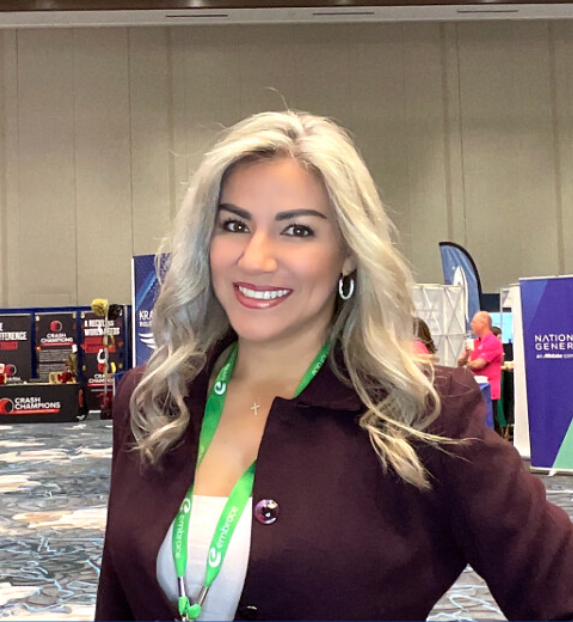 woman-smiling-in-maroon-jacket-at-smash-booth-trade-show-booth
