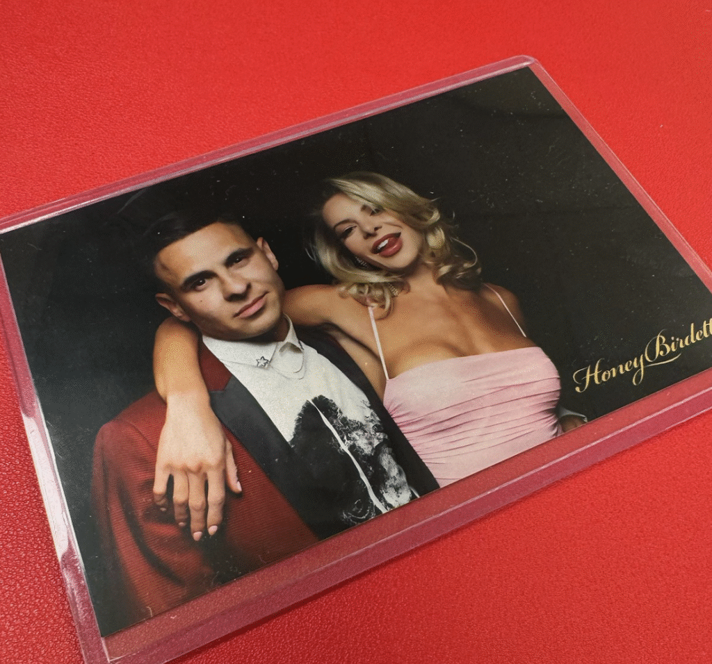 couple-smiling-in-photo-strip-with-red-background-at-las-vegas-smash-booth