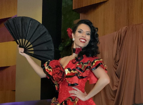 woman-in-red-dress-holding-black-hand-fan-smiling