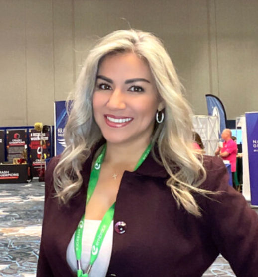 woman-in-black-dress-smiling-at-event-booth