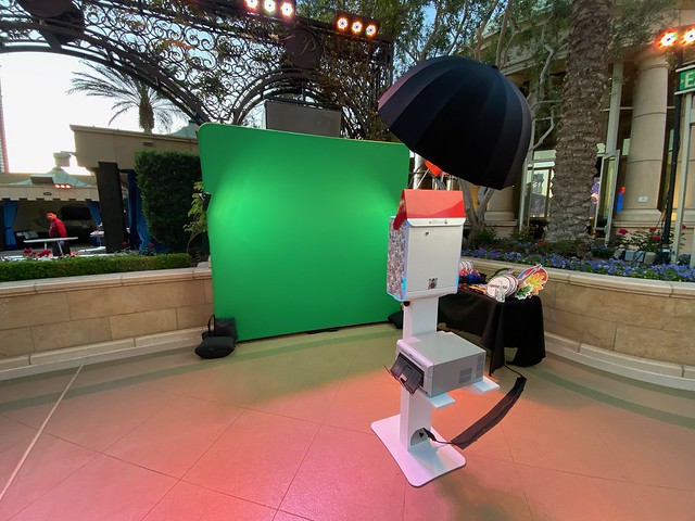 Smash-Booth-green-screen-photo-booth-setup-with-professional-lighting-luxury-camera-kiosk-and-themed-props-ready-for-an-immersive-guest-experience-at-a-stylish-outdoor-event