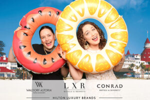 Guests-posing-with-inflatable-donut-props-at-custom-branded-photo-booth-for-Conrad-Las-Vegas-event