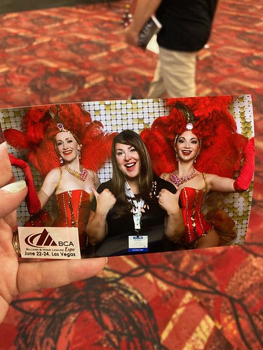group-of-women-in-red-themed-party-photo-booth-holding-props