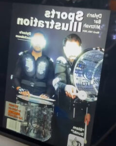 man-holding-multiple-award-plaques-at-smash-booth-recognition-event