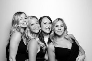 group-of-four-women-smiling-in-photo-booth