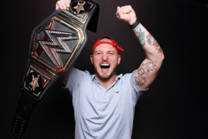 man-cheering-with-arm-raised-in-photo-booth