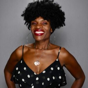 woman-in-black-polka-dot-dress-smiling