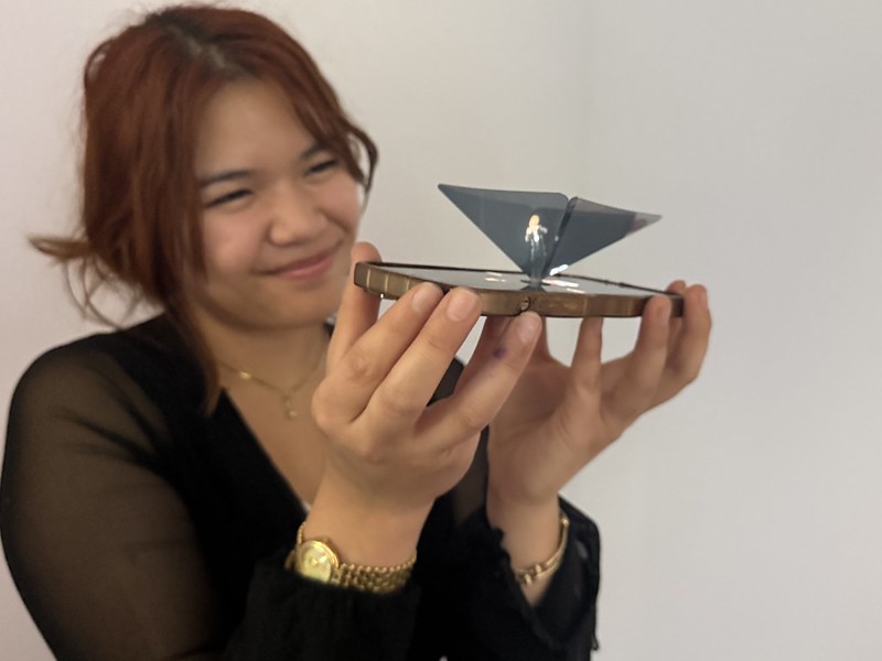 woman-smiling-and-holding-hologram-photo-booth-display