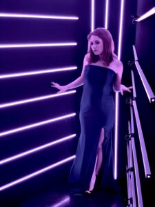 woman-posing-in-black-dress-inside-smash-booth-led-light-booth