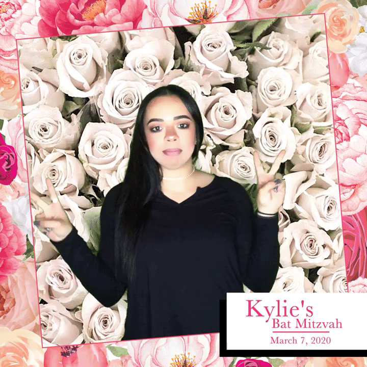 woman-standing-in-front-of-flower-wall-with-event-sign-at-smash-booth-las-vegas