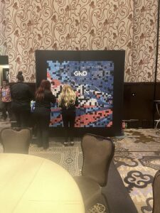 two-women-arranging-the-mosaic-photo-wall-in-an-event