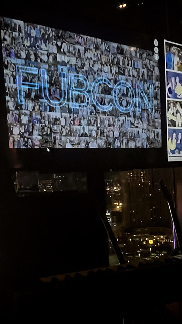 event-guests-viewing-large-projection-display-at-smash-booth-setup