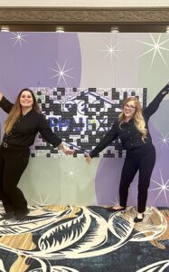 two-women-standing-by-interactive-photo-backdrop-at-smash-booth-las-vegas-event
