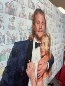 man-in-tuxedo-and-woman-in-evening-gown-smiling-at-knight-to-remember-las-vegas-photo-booth