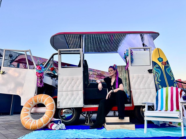 photo-booth-guests-posing-with-inflatable-props-in-retro-vw-bus-at-event