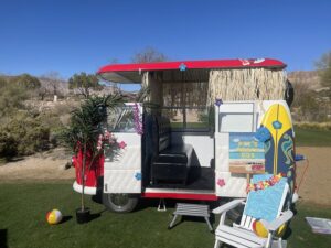 outdoor-photo-booth-with-rustic-backdrop-and-red-umbrella