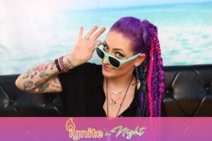 woman-with-purple-hair-and-sunglasses-saluting